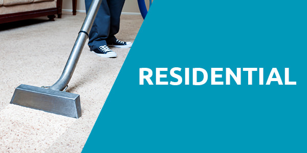 Man wearing a jeans with black and white shoes standing on a white carpet and is holding a steam carpet cleaner with a header title that says "Residential" with blue background and that is one of the services of carpet cleaning Albuquerque.