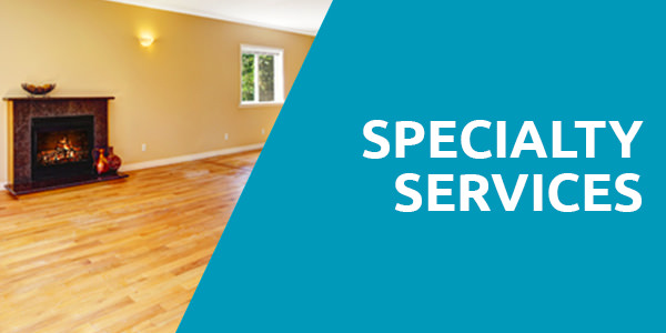 A chimney placed on a yellow wall with the light bulb, window and a wooden floor with a header title that says "Specialty Services" with blue background and that is one of the services of carpet cleaning Albuquerque.